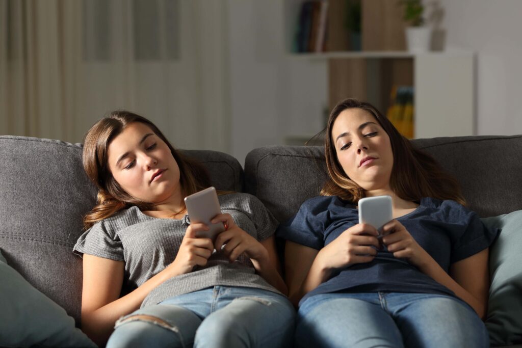 sitting on a sofa using a smartphone