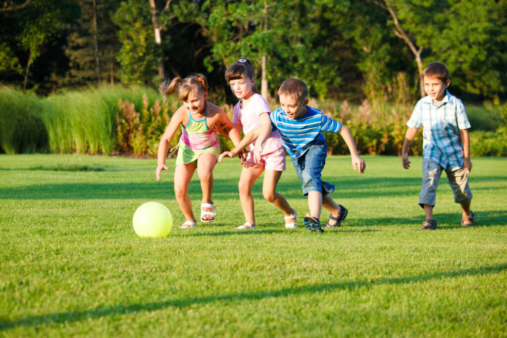 Children playing football outdoors