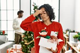 Parent feeling Christmas stress while preparing holiday gifts and decorations