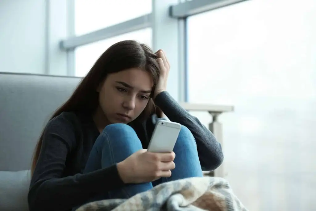 teen using phone and social media at home