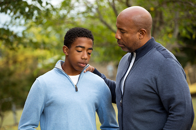 Parent supporting teenager as they prepare for a new school year